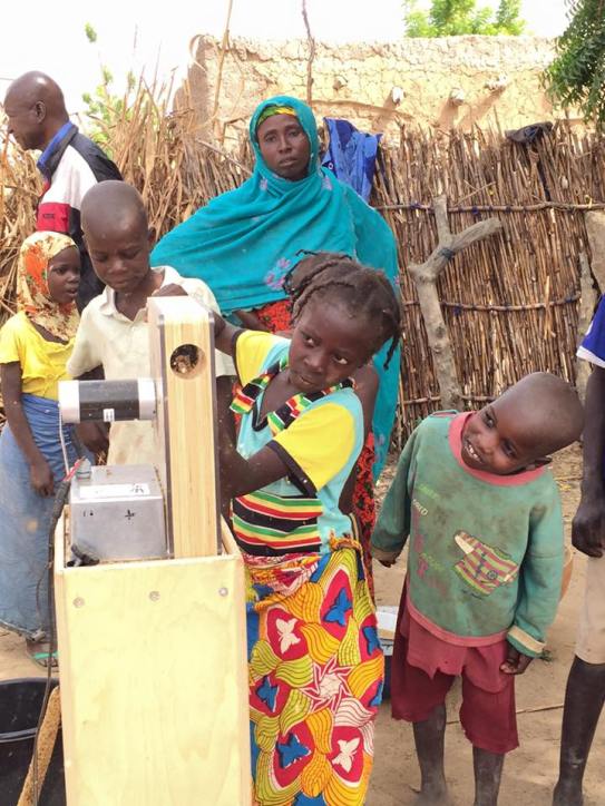 A child using the HIT AF2 prototype while another child watches through the side window in the prototype.