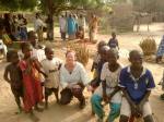 Susan posing for a photograph with several children.